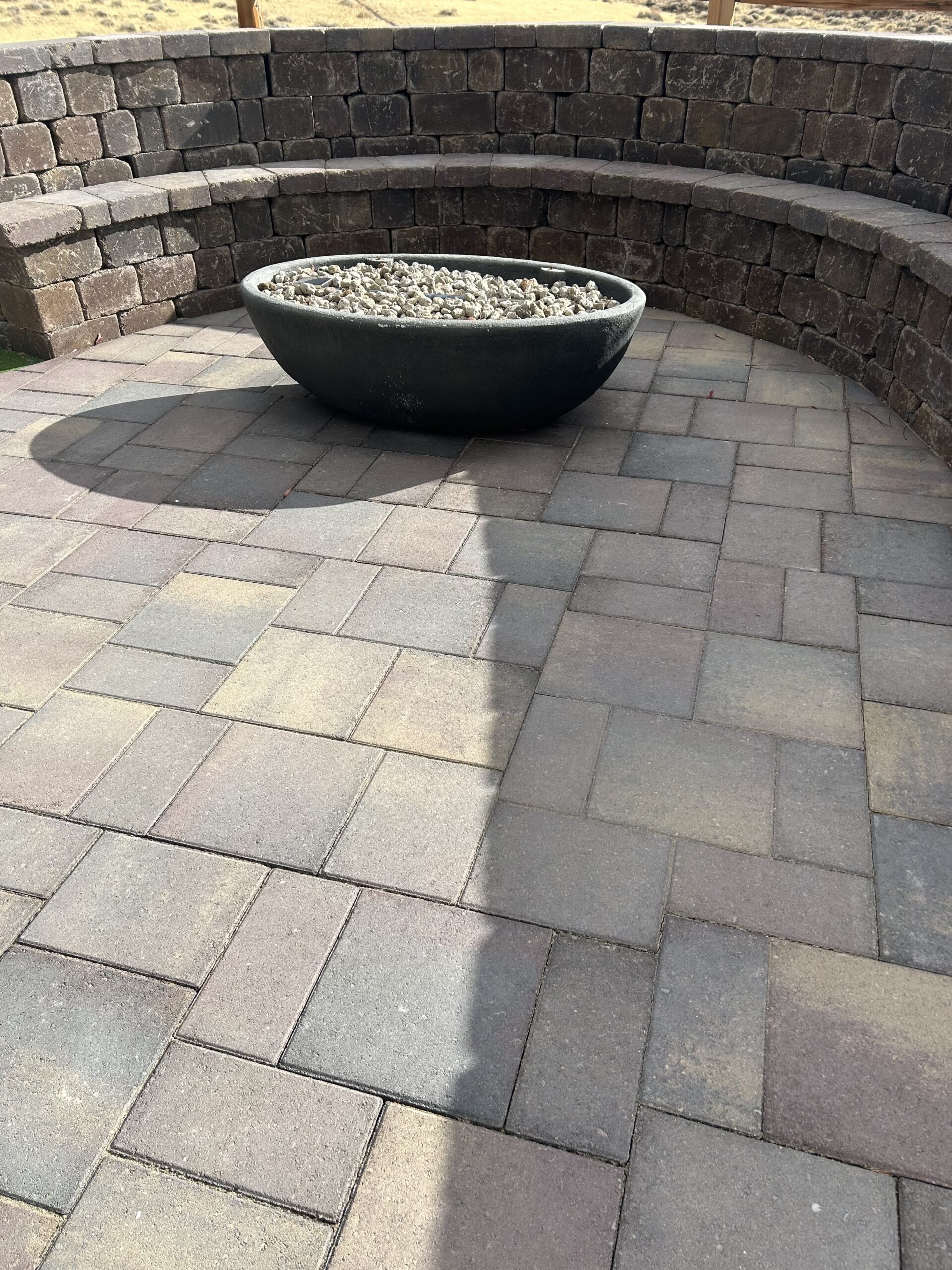 fire pit on a paver patio with retaining wall