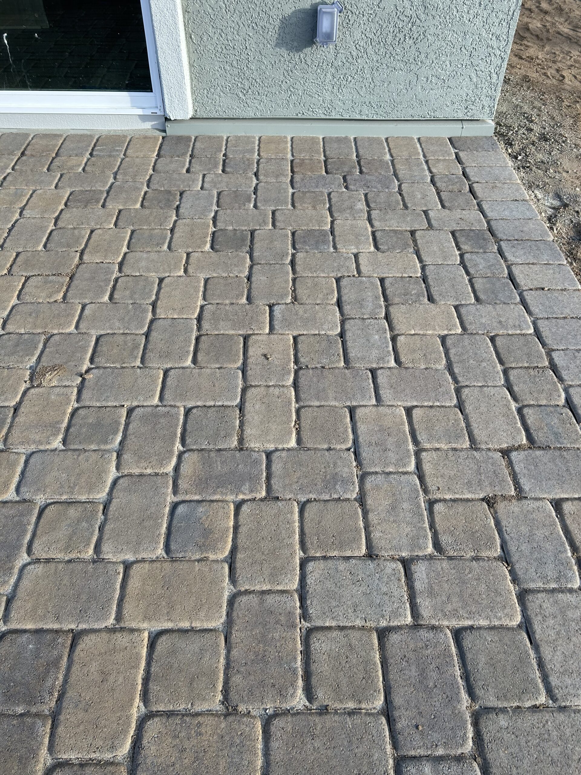 Paved patio with textured stones.