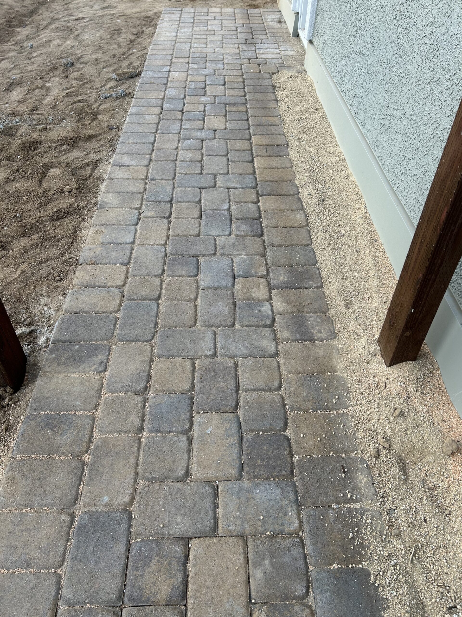Paved walkway beside a building.